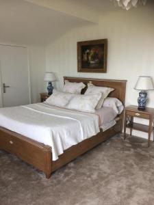 a bedroom with a large bed with two tables at Villa Erresiñolettean in Ciboure