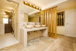 a bathroom with two sinks and a large mirror at Station in Adler