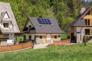 a house with solar panels on the roof at Domek Przystań Górska in Zakopane