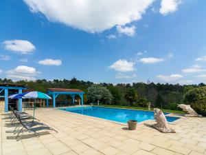 a swimming pool with a statue of a polar bear next to it at Beautiful holiday home with private pool in Saint-Cernin-de-lʼHerm