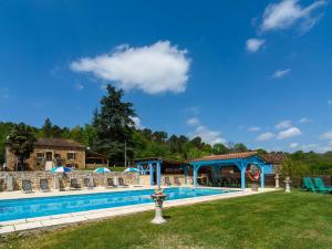 a pool at a resort with chairs and a pavilion at Beautiful holiday home with private pool in Saint-Cernin-de-lʼHerm