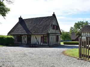 a black and white house with a fence at Holiday home with garden in Fontainejean