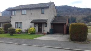 a house on a street with a driveway at Eagles View in Llanrwst