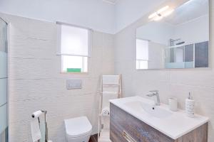 a white bathroom with a sink and a toilet at APARTAMENTO MICÁ in Albufeira +38 photos