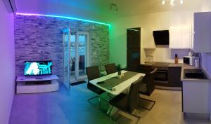 a kitchen and living room with a table and a television at Apartment Roko Kolinda 1 in Bibinje