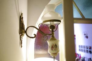 a lamp hanging on a wall next to a window at B&B Bianca in Catania
