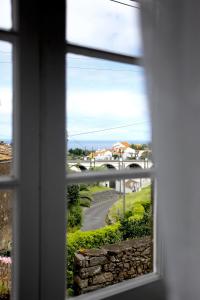 a window with a view of a road and a bridge at Casa da Roseira in Nordeste