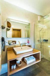 a bathroom with a sink and a shower at Waldhotel Kreuztanne in Sayda