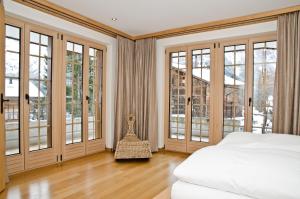 Postel nebo postele na pokoji v ubytování Chalet Rivendell - GRIWA RENT AG