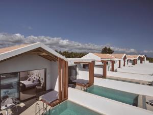a view of a villa with a swimming pool at Hotel St.John Suites Adults Only in Tsilivi