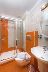 a bathroom with a shower and a toilet and a sink at Ouranoupolis Princess in Ouranoupoli