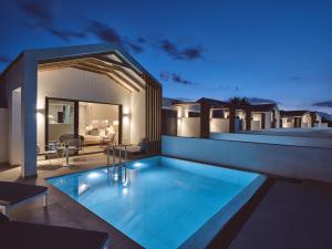 a house with a swimming pool at night at Hotel St.John Suites Adults Only in Tsilivi