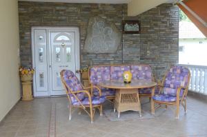 a dining room with a table and chairs and a brick wall at Villa St.George in Katerini