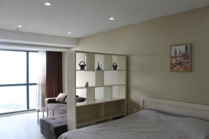 a bedroom with a bed and a book shelf at Batumi Porta Tower 1611 in Batumi