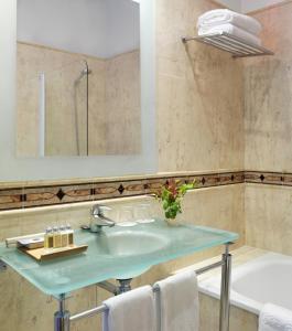 
a sink and a mirror in a bathroom at Hotel Villa Rosario in Ribadesella
