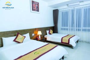 a hotel room with two beds and a window at Hai Tien Plaza Hotel in Mỹ Ðuc +29 photos
