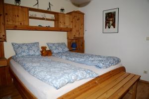 a bedroom with a large bed with blue pillows at Ferienwohnung Ackermann Oberallgäu in Missen-Wilhams