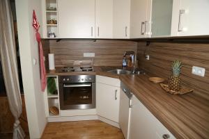 a small kitchen with white cabinets and a sink at Ferienwohnung Ackermann Oberallgäu in Missen-Wilhams