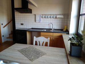 a kitchen with a sink and a table with a chair at Katharina in Kempen