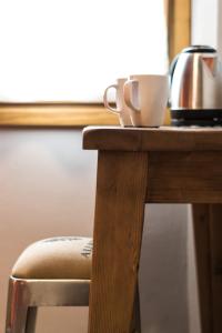 - une table en bois avec une bouilloire et une tasse dans l'établissement B&B L'Eroico, à Gaiole in Chianti