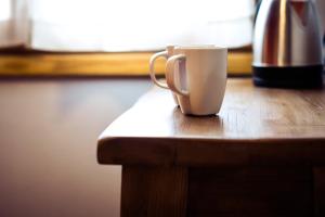 una taza de café sobre una mesa de madera en B&B L'Eroico en Gaiole in Chianti