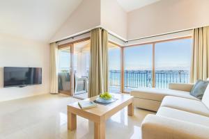 a living room with a couch and a tv and a table at Luxury Apartments Villa Matea 2 in Malinska