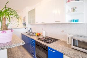 a kitchen with blue cabinets and a sink at Apartments Stasic in Vrbnik