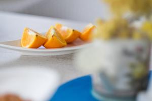 a plate of orange slices on a table at Apartments Stasic in Vrbnik