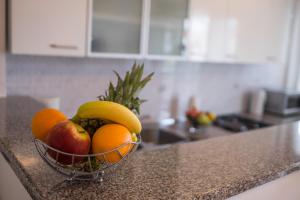 a bowl of fruit on a counter in a kitchen at Apartments Stasic in Vrbnik