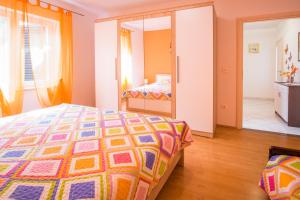 a bedroom with a bed and a mirror at Apartments Stasic in Vrbnik