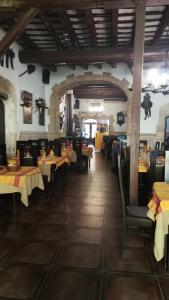 a restaurant with tables and chairs in a room at Hostal Restaurante La Diligencia in Cunit