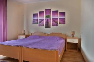 a bedroom with a bed with purple sheets at Apartments Lavandula Baska in Baška