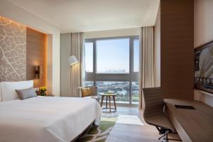 a hotel room with a bed and a desk at Al Bandar Arjaan by Rotana – Dubai Creek in Dubai