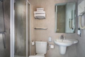 a bathroom with a toilet and a sink and a shower at L'Esterel in Cannes