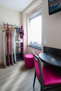 a dressing room with a table and a pink chair at L'Esterel in Cannes