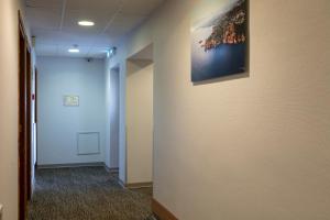 a hallway with a painting hanging on a wall at L'Esterel in Cannes