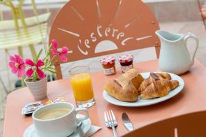 a table with a plate of pastries and a cup of orange juice at L'Esterel in Cannes