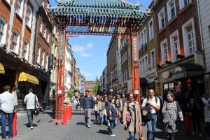 a group of people walking down a street at Central London rooms in London +28 photos