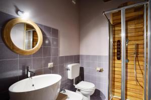 a bathroom with a sink and a toilet and a mirror at Albergo Passepartout in Scopello