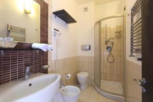 ジャルディーニ・ナクソスにあるHotel San Giovanniのバスルーム(バスタブ、トイレ、シャワー付)