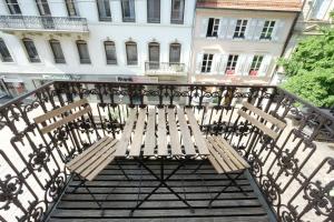 a pair of wooden benches sitting on a balcony at Boutique Charme Apartments in Baden-Baden