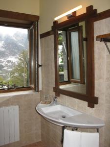 a bathroom with a sink and a window at La Posada de Cucayo in Dobres