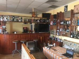 a bar with a table and stools in a room at Family Hotel - Relax in Ruse