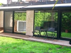 a patio with a table and chairs on a deck at La Tana dei Dalmatini in San Benedetto del Tronto