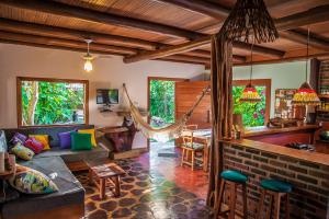 a living room with a couch and a hammock at Casa Rústica in Arraial d'Ajuda
