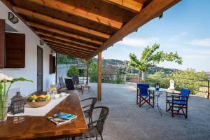 a patio with a table and chairs with a view at Samarian Cottage in Lákkoi