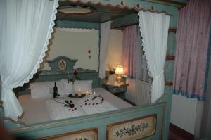 a bedroom with a canopy bed with candles on it at Hotel Gasthaus Schwarzenstein in Ginzling