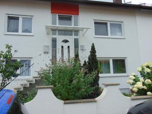 a white house with stairs and flowers in front of it at Gästehaus Brandenburger in Speyer