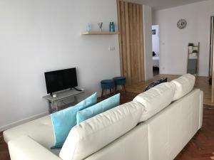 a white couch with blue pillows in a living room at Fátima4You in Fátima