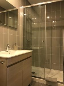 a bathroom with a glass shower and a sink at Fátima4You in Fátima